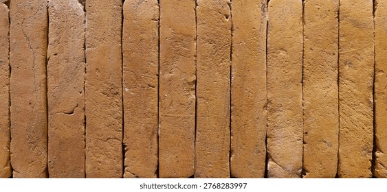 Rustic Clay Brick Wall Texture Background With Vertical Adobe Bricks And Earth Tones Closeup