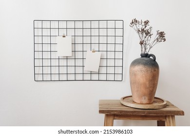Rustic Clay Vase With Dry Hypericum Bouquet On Wooden Table. Black Metal Mesh Noticeboard, Bulletin Board With Blank Memo Cards Mockups. Elegant Home Office Interior Concept. White Wall Background.