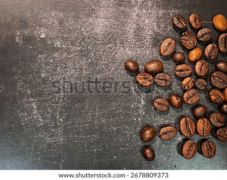 Rustic Coffee Beans Spilled Over Dark Background with Soft Shadows