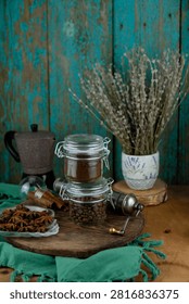 Rustic Coffee Composition with Ground Beans, Whole Roasted Beans, Moka Pot and Star Anise Pods stilllife green background