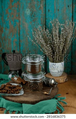Rustic Coffee Composition with Ground Beans, Whole Roasted Beans, Moka Pot and Star Anise Pods stilllife green background