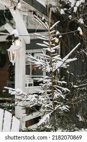 Rustic Country House In Winter In Snow, Front Porch Of Suburban Area With Stylish Decor, Atmosphere Of Christmas And New Year Celebration Background And Christmas Tree