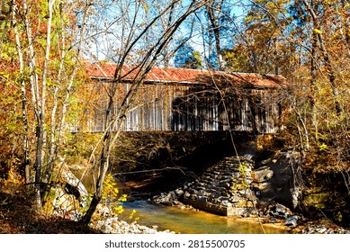rustic covered bridge over  a creek