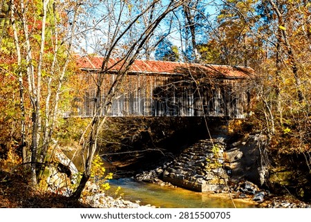 rustic covered bridge over  a creek
