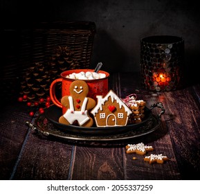 Rustic and Cozy winter Christmas setting. Hot cocoa in a red mug with marshmallows and homemade gingerbread cookies. - Powered by Shutterstock