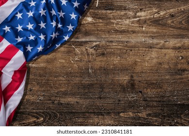 Rustic dark wood table with American flag on it with free space for any text. Perfect for textures around Memorial Day, Labors Day, Veterans Day or Independence Day. - Powered by Shutterstock