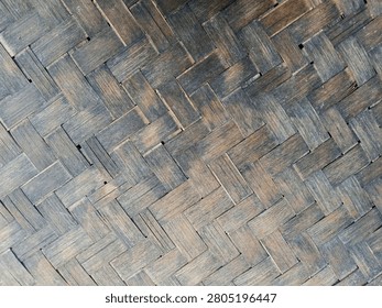 Rustic dark woven bamboo texture pattern background, traditional vintage wickerwork surface close up.