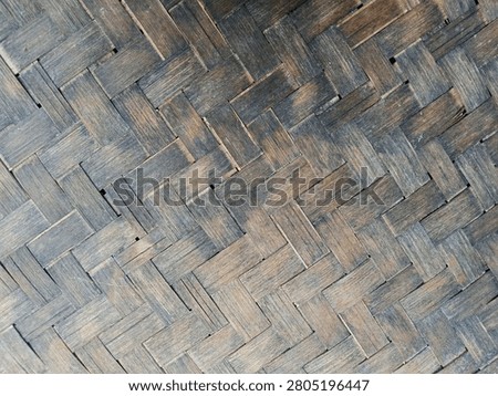 Rustic dark woven bamboo texture pattern background, traditional vintage wickerwork surface close up.