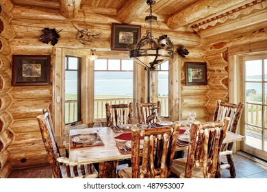 A rustic dining room, with comfortable furnishings, in a modern log cabin in the mountains.