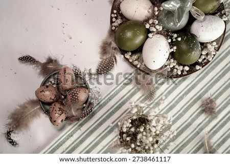 Rustic Easter still life with olive eggs and decor. A detailed shot of a plate with speckled white and green eggs, decorated with delicate flowers and feathers, focusing on a cute bunny in the center.