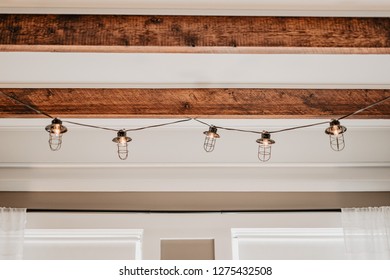 Rustic Edison Bulb String Lights Hanging On A Wooden Ceiling 