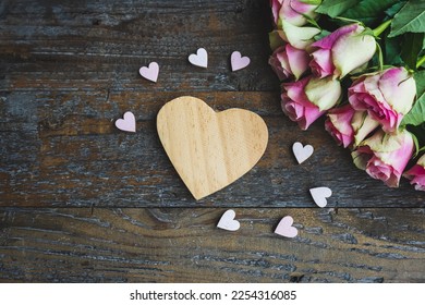  Rustic flat lay mockup for valentines day, wedding, love - wooden heart with copyspace and little pink and white wooden hearts combined with a bunch of pink roses on rustic wooden underground - Shutterstock ID 2254316085