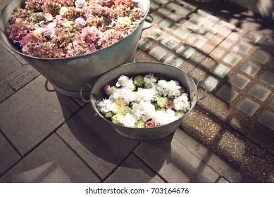 Rustic galvanised pails filled with summer flowers