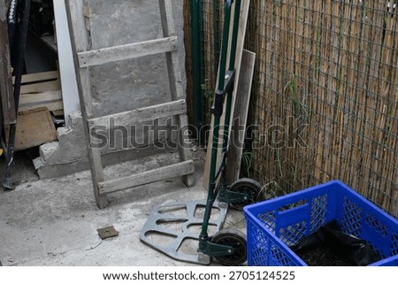 Rustic garden corner with abandoned tools whispers tales of earthy toil and tranquil Yule tide, evoking solstice dreams