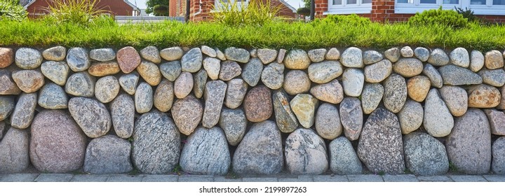 Rustic garden wall with wackerstones. - Shutterstock ID 2199897263