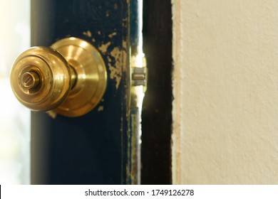 Rustic Gold Vintage Doorknob On Antique Door.