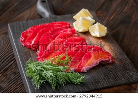 Rustic gravlax presentation combines fresh dill lemon and artisan seafood preparation