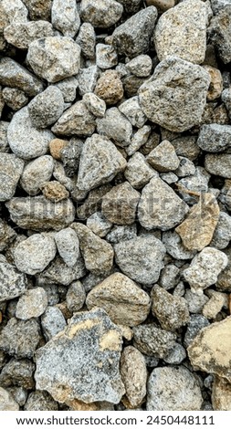 Rustic gray pebbles with moss accents, ideal for natural and textured backgrounds