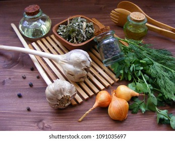 rustic greenery : fresh parsley and dill, onion, garlic, olive oil in glass, dry spices in bowl and juniper berries - Powered by Shutterstock