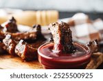 Rustic Grilled BBQ Ribs with Red Sauce Pork and Beef Roasted on Charcoal Wooden Background Delicious Meal.