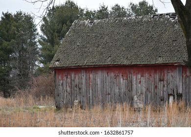 rustic historic red barn with wood shingles