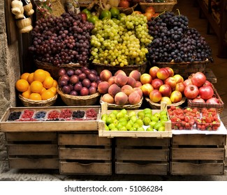 A rustic Italian storefront  featuring a colorful variety of delicious fruit.