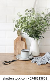 Rustic Kitchen Interior. Still Life Composition With Cup Of Coffee, Wooden Chopping Boards And Cow Parsley Bouquet In Jug. White Brick Wall, Metro Tiles. Scandinavian Design. Home Staging, Concept, 