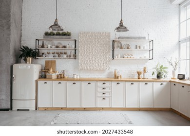 Rustic Kitchen Interior With White Brick Wall. Modern Room Design With Wooden Furniture, Cozy Home With Vintage Decoration. Tabletop With Food, Shelves With Ceramic Kitchenware.