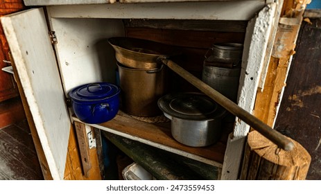 Rustic kitchen shelving with vintage pots and pans, creating an oldfashioned nostalgic look - Powered by Shutterstock