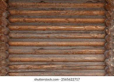A rustic log cabin wall with horizontally aligned wooden logs.