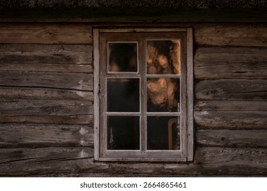 Rustic Log cabin and window with a reflection of sunrise. Old wooden log house window background.