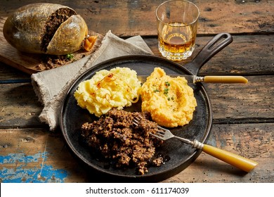 Rustic meal of haggis, neeps and tatties served with a tumbler of whisky to celebrate Robert Burns Supper in a high angle view - Shutterstock ID 611174039