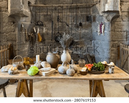 Rustic Medieval Kitchen Table with Fresh Bread Vegetables and Vintage Cooking Utensils