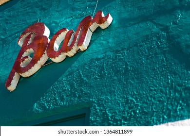 Rustic Metal Bar sign on a teal colored textured wall  - Shutterstock ID 1364811899