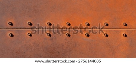 Rustic Metal Surface with Rivets Showcasing Industrial Texture and Design