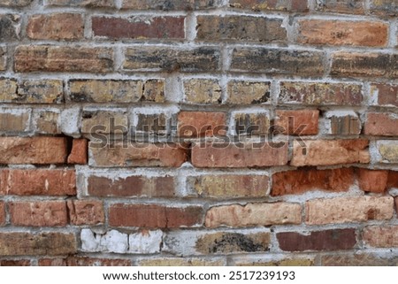 rustic multicolor stone brick wall with cracked texture background. concept of foundation and tuckpointing. architectural detail design element