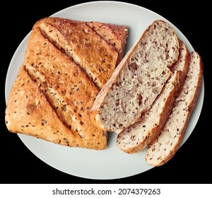 Rustic Multigrain Bread Sliced Loaf on White Ceramic Platter Isolated on Black Background