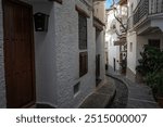 Rustic narrow alley with white buildings featuring wooden doors and window shutters on a sunny day, Alpujarras, granada, andalucia, espa a