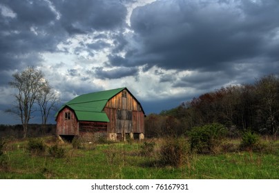 A rustic old barn under stormy skies.