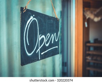 Rustic Open Sign Hanging In The Door Of A Coffee And Gift Shop In The Pacific Northwest