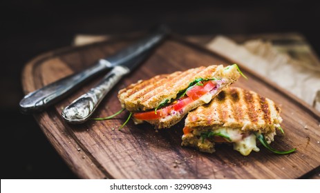 rustic panini on wooden board, selective focus - Shutterstock ID 329908943