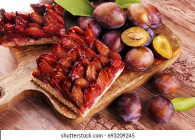 Rustic Plum Cake On Wooden Background With Plums Around