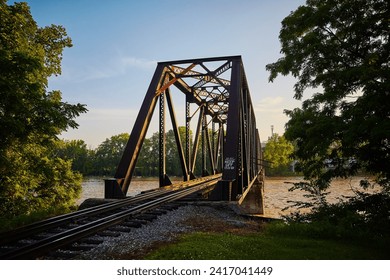 Rustic Railroad Truss Bridge at Golden Hour, Ohio Riverbank Perspective - Powered by Shutterstock