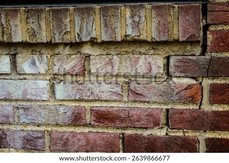 rustic red brick building facade detail. tuckpointing construction concept. abstract beauty in architecture. construction tuckpointing concept. crack in wall.
