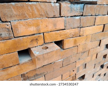 Rustic red brick wall texture featuring a single missing brick. A perfect conceptual background for themes of gaps, architectural flaws, hidden secrets, or 