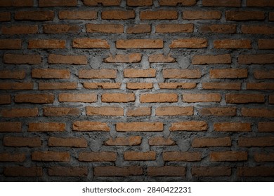 Rustic red brick wall texture background with center spotlight, dramatic dark vignette clay brickwork.