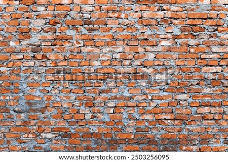 Rustic Red Brick Wall Texture. The wall showcases a rough texture with varying shades of red, orange, and gray. Ideal for backgrounds, architectural designs, or industrial-themed projects.