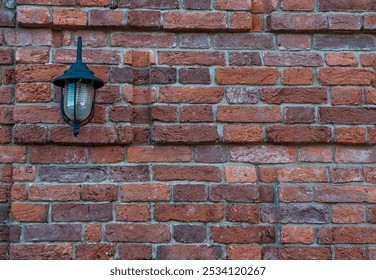 Rustic red brick wall with vintage outdoor lamp casting a soft shadow - Powered by Shutterstock