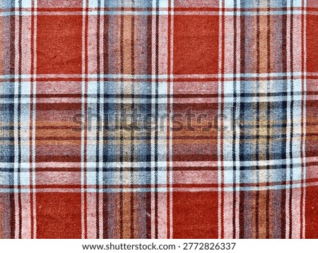 rustic red plaid fabric texture interwoven blue brown white stripes closeup pattern