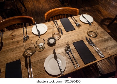 A Rustic Restaurant Table Set For Service.